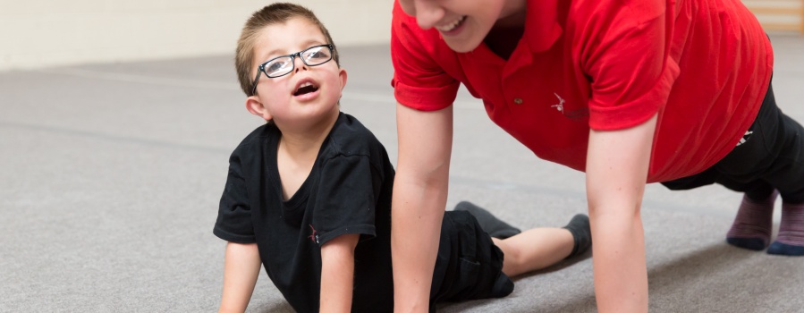 Coach and gymnast practising press up position  